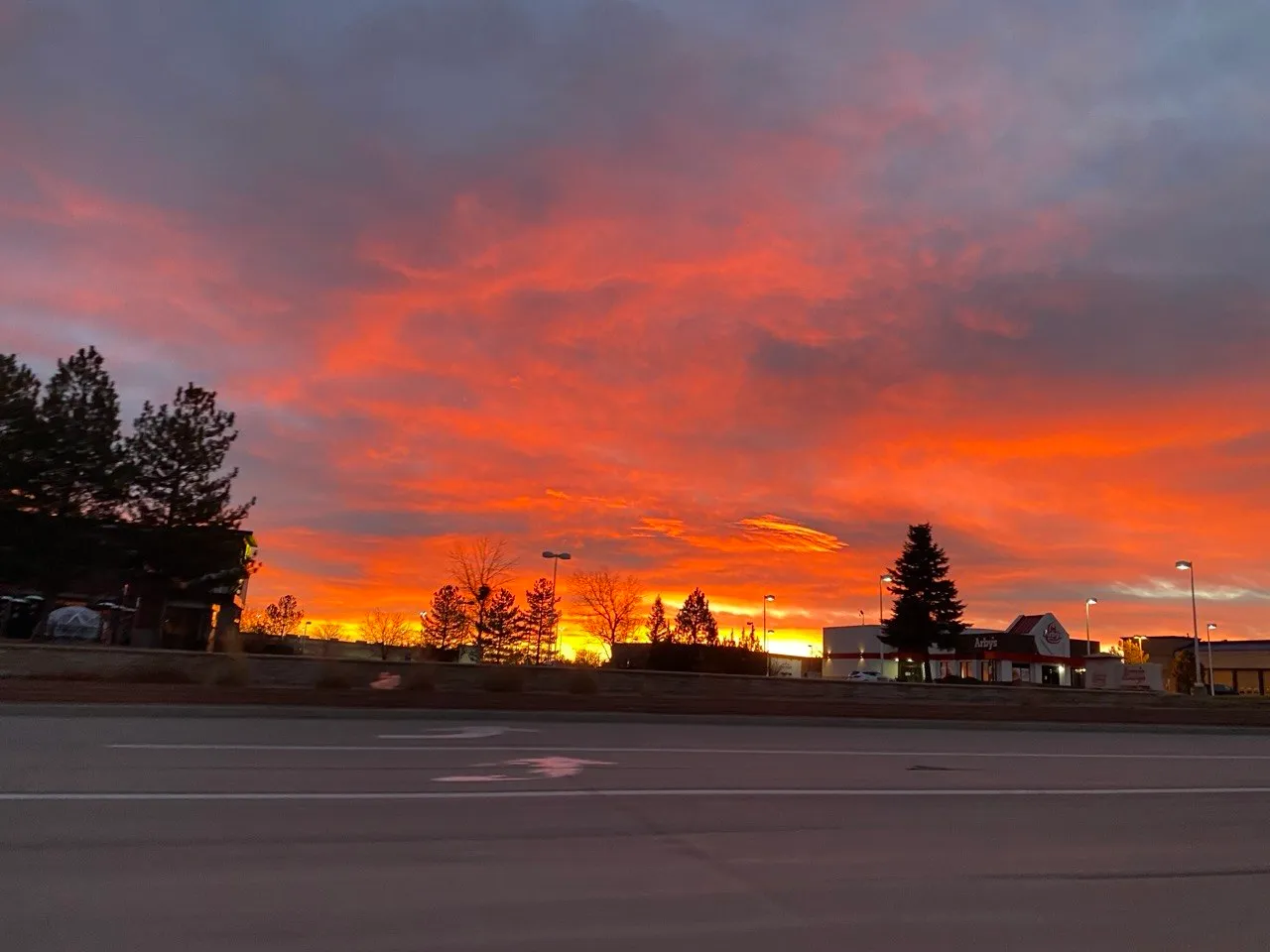 A red and orange sunset over a Denver street
